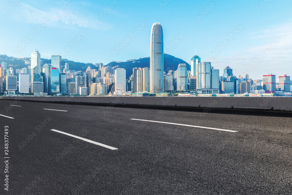 Road and skyline of modern urban architecture in Hong Kong..