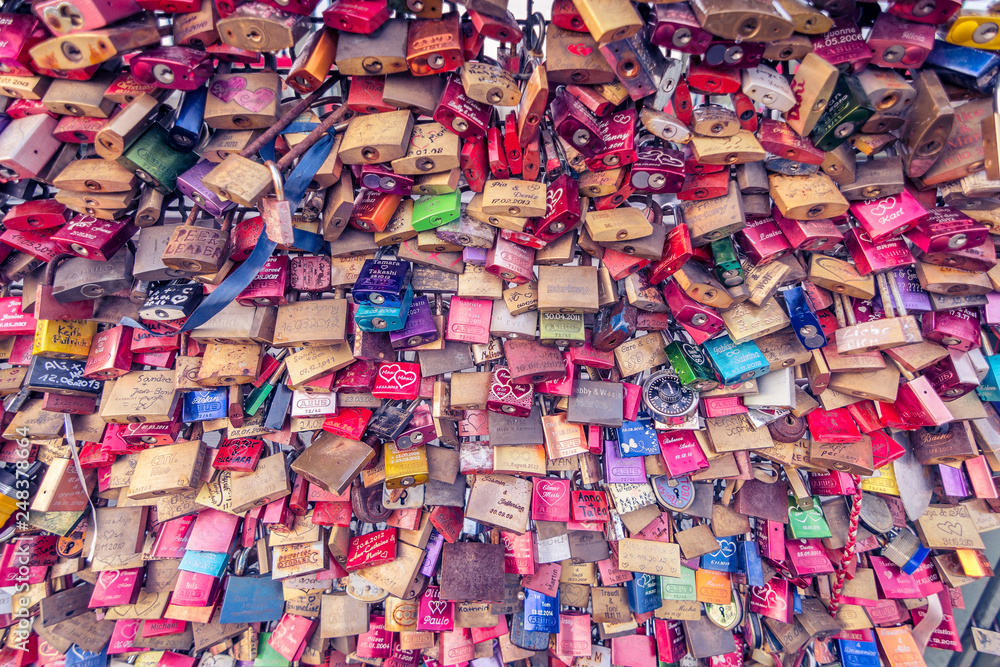Love locks chained to bridge. Entire frame filled with symbolic locks of love. Hohenzollern Bridge in Cologne, Germany. Love locks chained to bridge. Entire frame filled with symbolic locks of love. Hohenzollern Bridge in Cologne, Germany.
