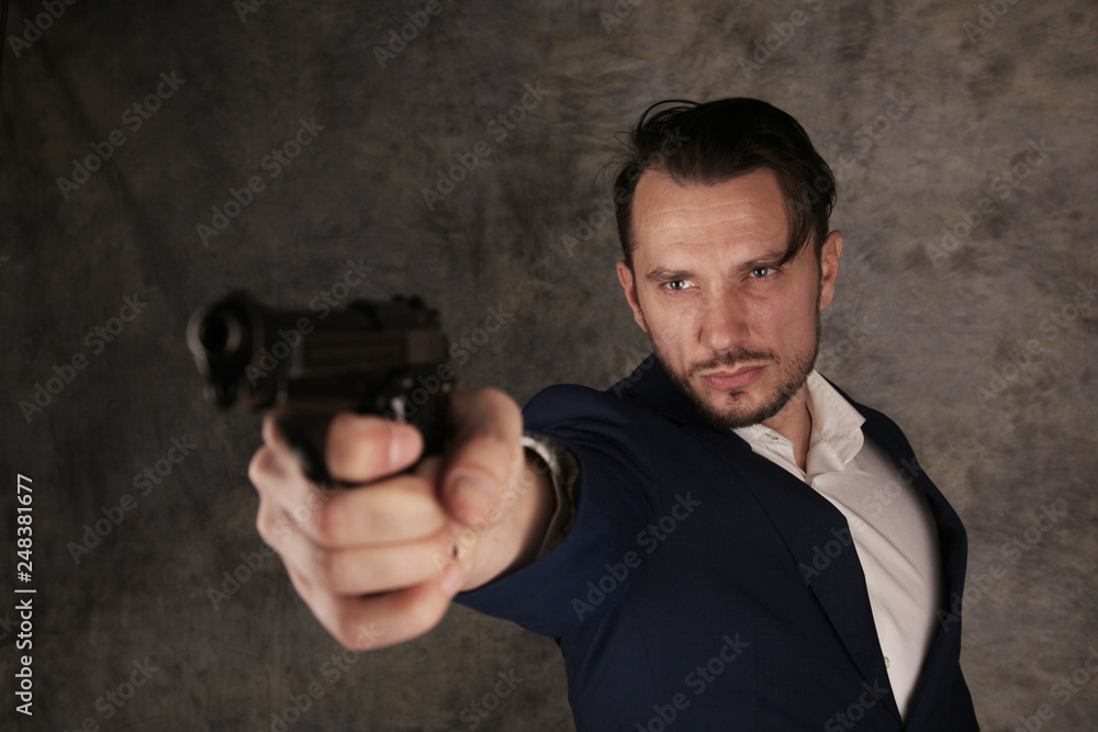Handsome man aims with gun Handsome man aims with gun