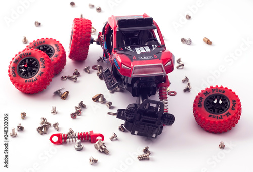 Disassembled car and scattered parts. Broken toy