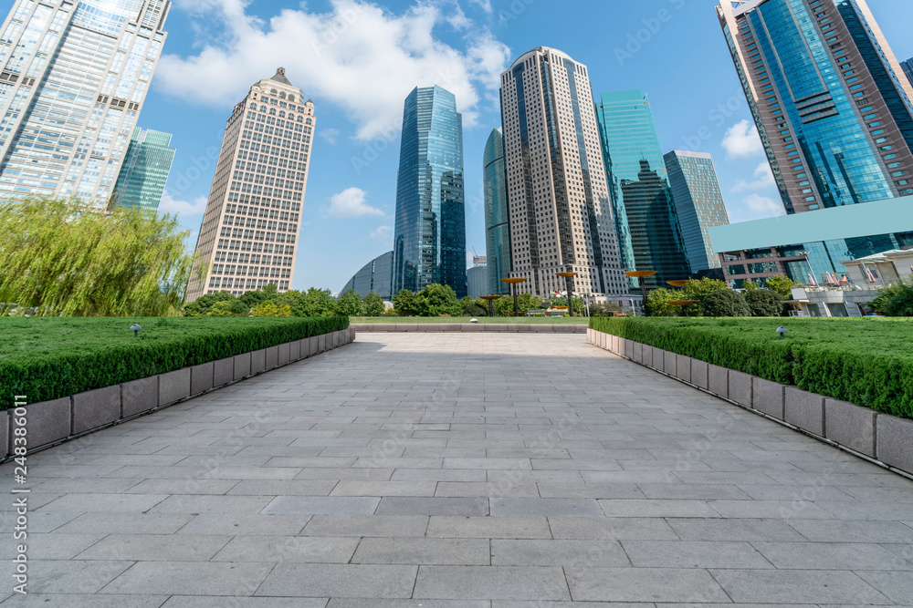 Empty square floor tiles and skyline of modern urban buildings in Shanghai..