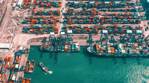 HONG KONG - MAY 2018: Aerial timelapse view of port, containers and fixed cranes from above, fast work activities. photo