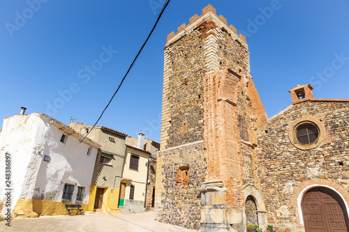 a street and the tower of the church in Badenas village, province of Teruel, Aragon, Spain photo