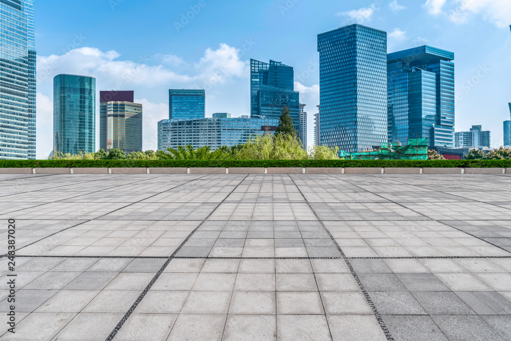 Empty square floor tiles and skyline of modern urban buildings in Shanghai..