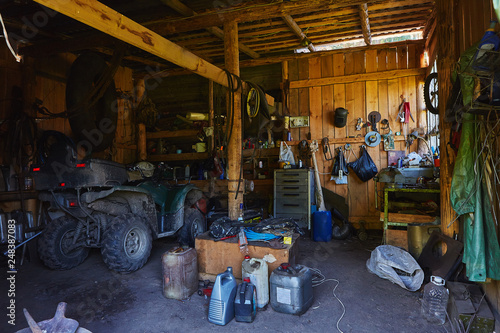 Miass, Russia, 23 July 2018: Workshop shed garage with toold for repare and atv inside photo