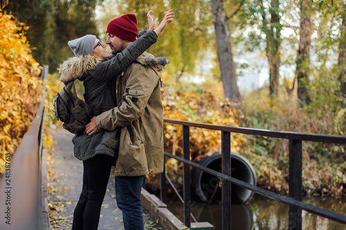 Two young travel couple walking on bridge