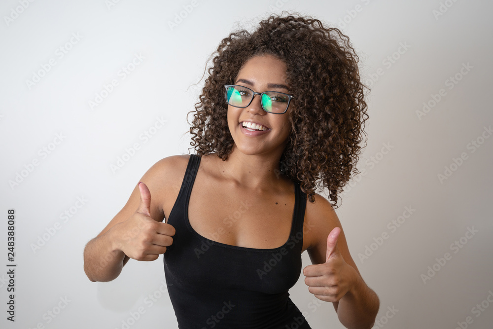 Portrait of young beautiful african american girl with afro. Girl wearing eyeglasses. Closeup. Studio shot. Portrait of young beautiful african american girl with afro. Girl wearing eyeglasses. Closeup. Studio shot.