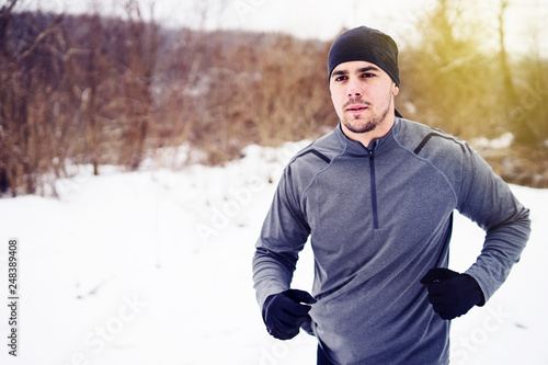 Young Man running, training for the Ultra trail Marathon in winter day © Miljan Živković