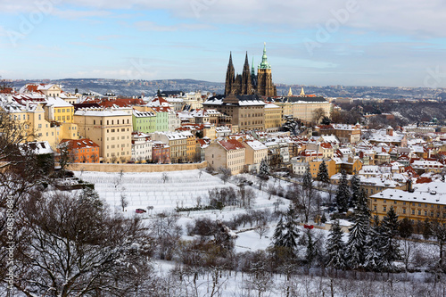 Snowy Prague City with gothic Castle from Hill Petrin in the sunny Day, Czech republic