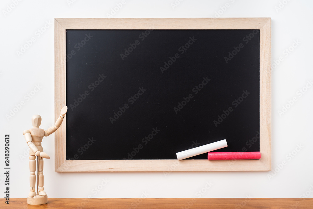 blackboard with wood puppet on teak floor blackboard with wood puppet on teak floor