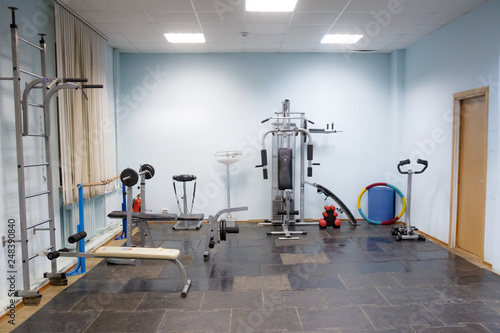 empty gym for fitness and bodybuilding with fitness equipment and dumbbells.