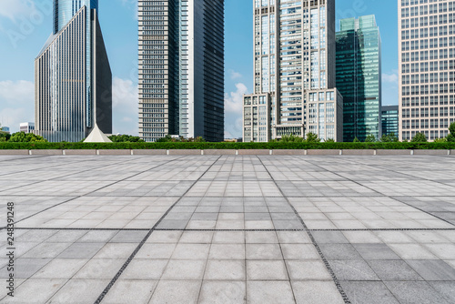 Empty square floor tiles and skyline of modern urban buildings in Shanghai..