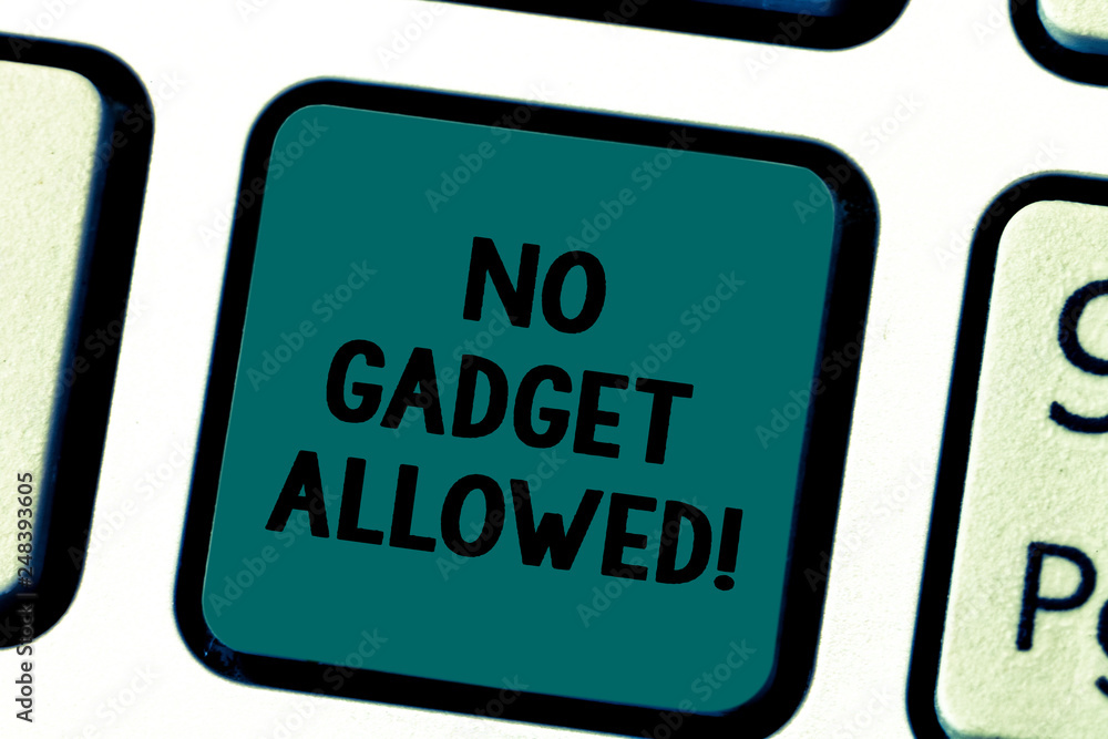 Fototapeta premium Writing note showing No Gadget Allowed. Business photo showcasing do not enter small mechanical or electronic device or tool Keyboard key Intention to create computer message pressing keypad idea