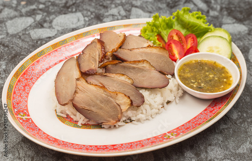 roasted duck meat topping rice dressing sweet sauce and pickled ginger on plate