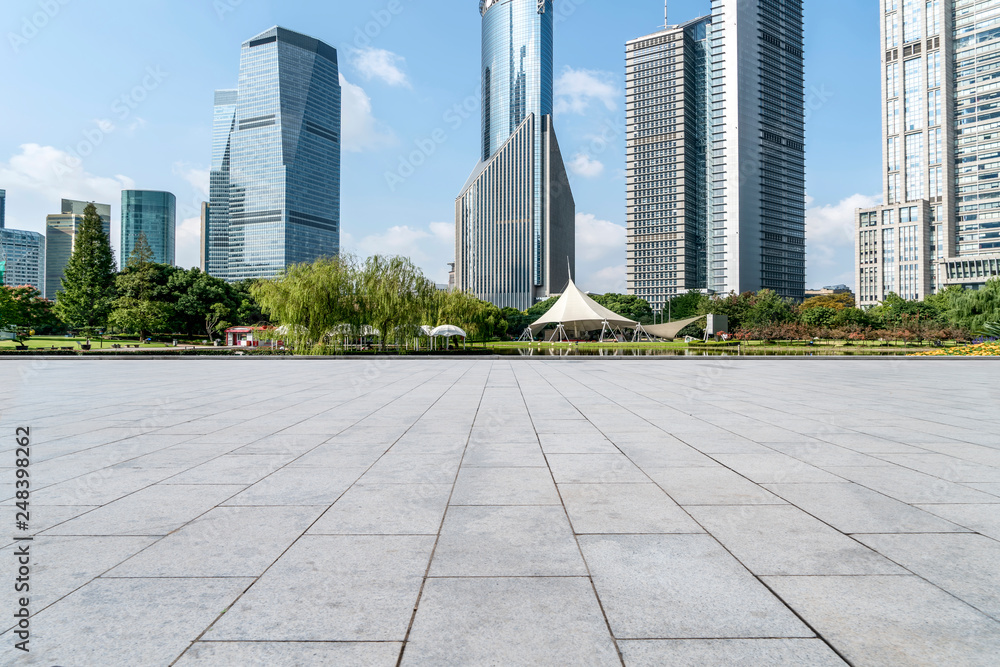 Empty square floor tiles and skyline of modern urban buildings in Shanghai..