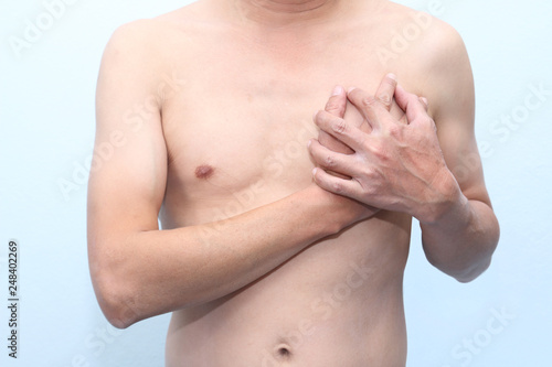 Man holding his chest with both hands  having heart attack or painful cramps