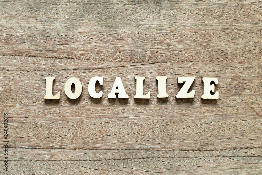 Fototapeta premium Letter block in word localize on wood background