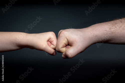 father and son fist bump 