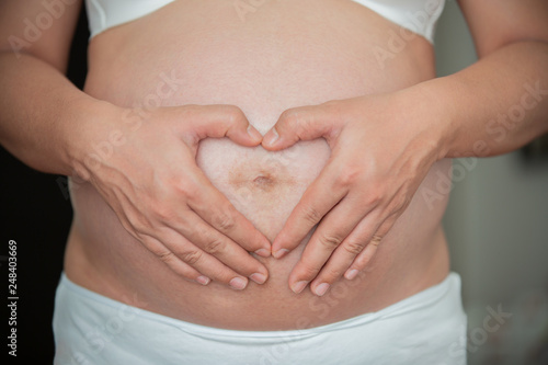 Wallpaper Mural Pregnant woman in white underwear and drawing heart by hand. Mom Waiting to meet a baby as unborn, lovely and healthy concept. Torontodigital.ca