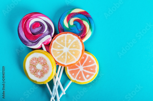 lollipops of different colors on a blue background. sweets and candies