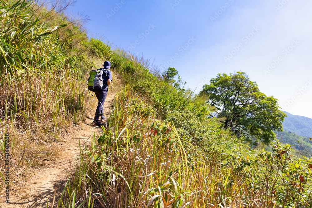 Young man climb a mountain alone. Mountain in Thailand, Khao Chang Puak in Kanchanaburi province