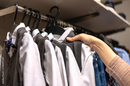 a women choosing new clothes, shopping in fashion mall, close up of hands