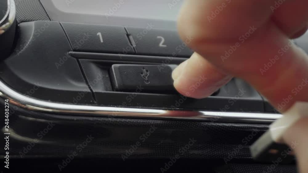 Female Hand Removing USB Cable in Car Female Hand Removing USB Cable in Car