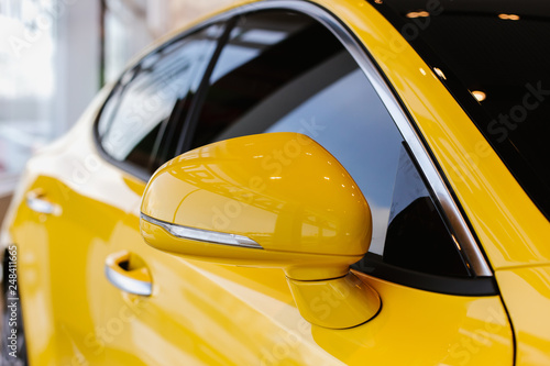 Chrome yellow car design elements - rear-view mirror and the right side of the body © Татьяна Скорина