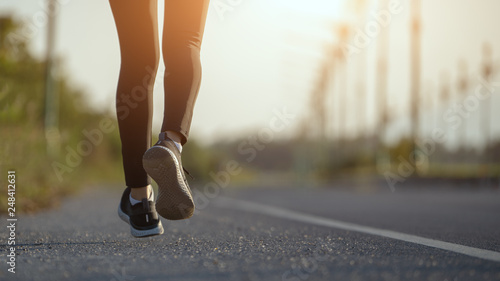 Young woman runner running on city bridge road, Young fitness woman runner athlete running at road 