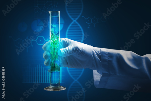 Scientist holding test tube...