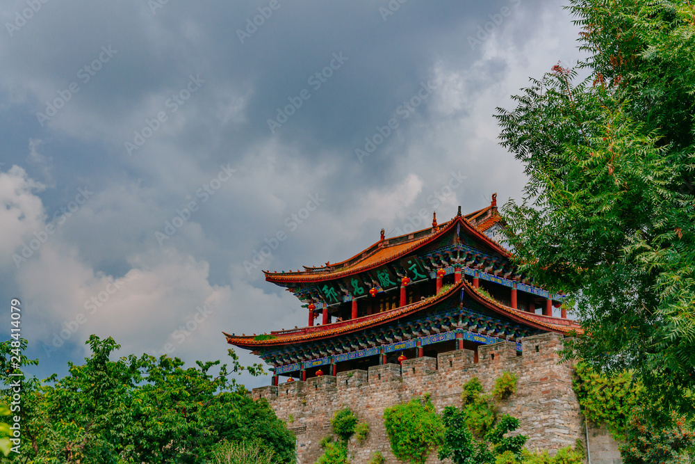 Traditional Chinese gate tower building in old town of Dali under sky and clouds, in Dali, Yunnan, China