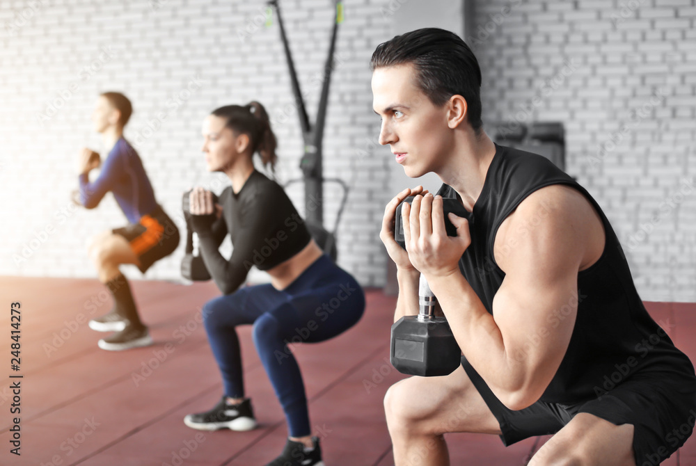 Group of athletes working out in gym Group of athletes working out in gym