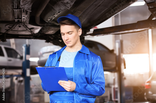 Male mechanic with clipboar...