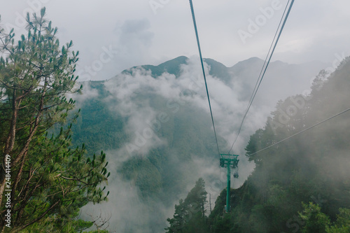 Cable cars traveling in Cangshan Mountains covered in clouds and fog in Dali, Yunnan, China © Mark Zhu