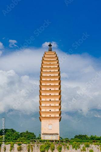 One of the three pagodas of Chongsheng Temple against Cangshan Mountains covered in clouds in Dali, Yunnan, China