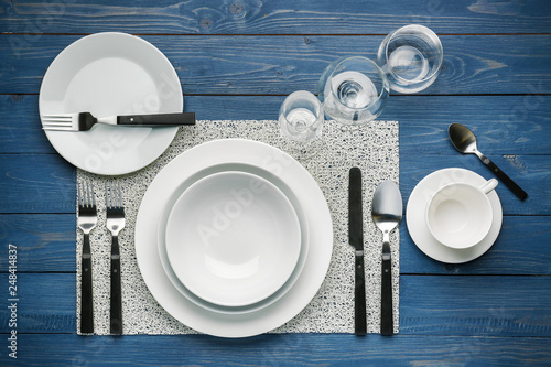 Simple table setting on color wooden background