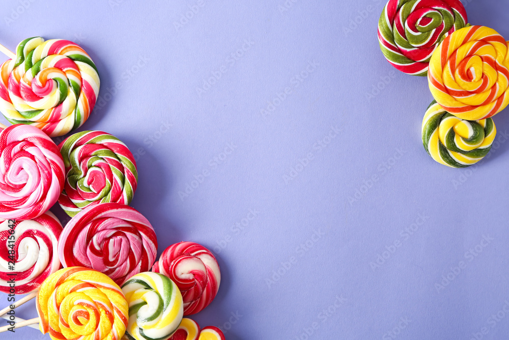 Sweet lollipops on color background
