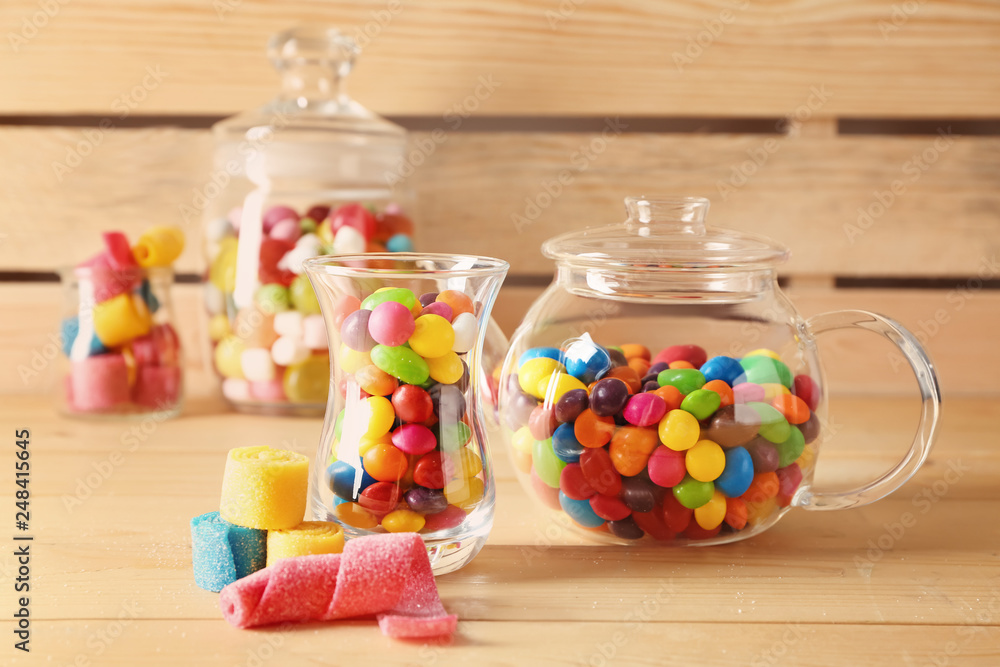 Glassware with different sweets on wooden background Glassware with different sweets on wooden background