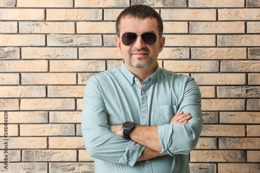 Handsome mature man near brick wall Handsome mature man near brick wall