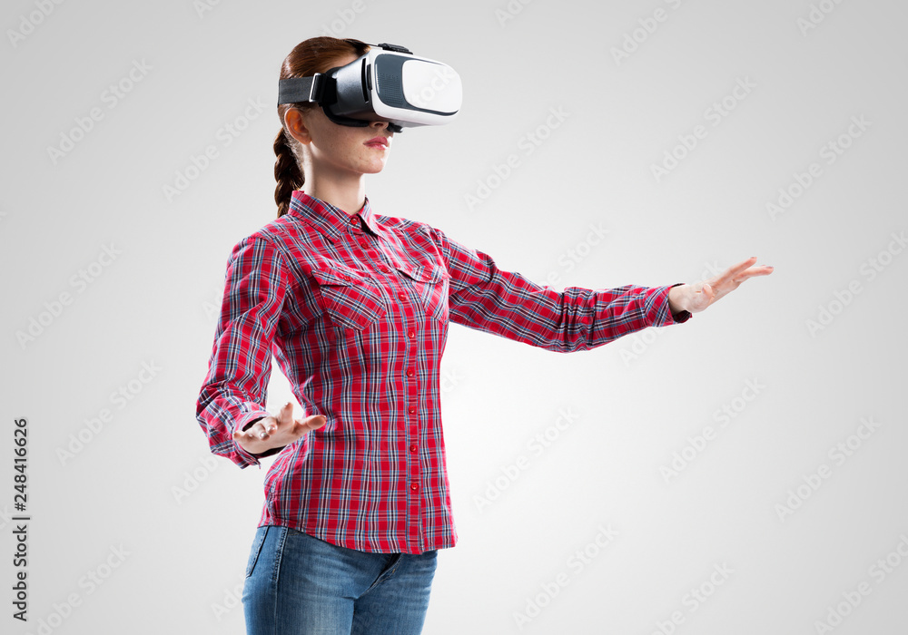 Fototapeta premium Girl in mask experiencing virtual reality as new entertainment device