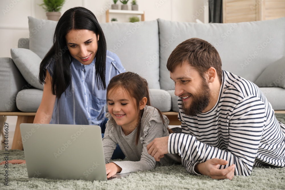 Happy family using laptop at home Happy family using laptop at home