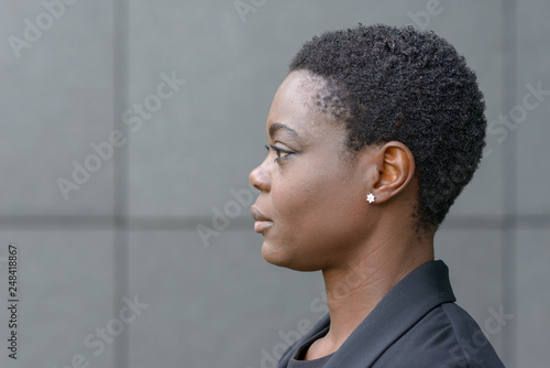 Wall Mural Close-up side portrait of young black woman