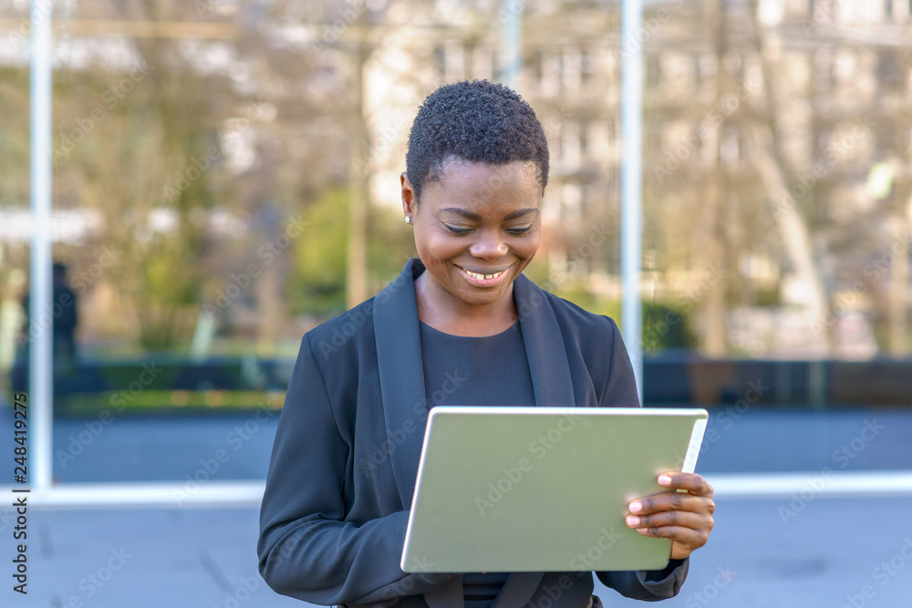 Happy young African woman using a tablet Happy young African woman using a tablet