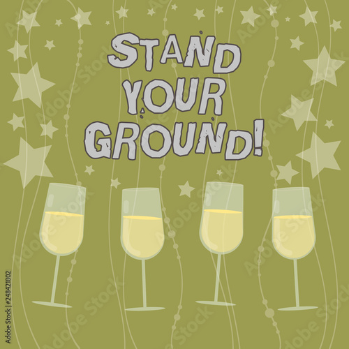 Text sign showing Stand Your Ground. Conceptual photo maintain ones position typically in face of opposition Filled Cocktail Wine Glasses with Scattered Stars as Confetti Stemware photo