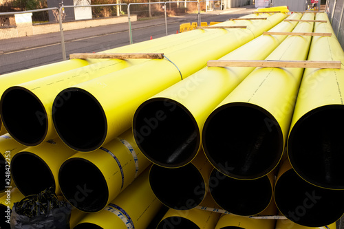 Gas yellow pipes and coil stacked on pallet at construction road works © Richard Johnson