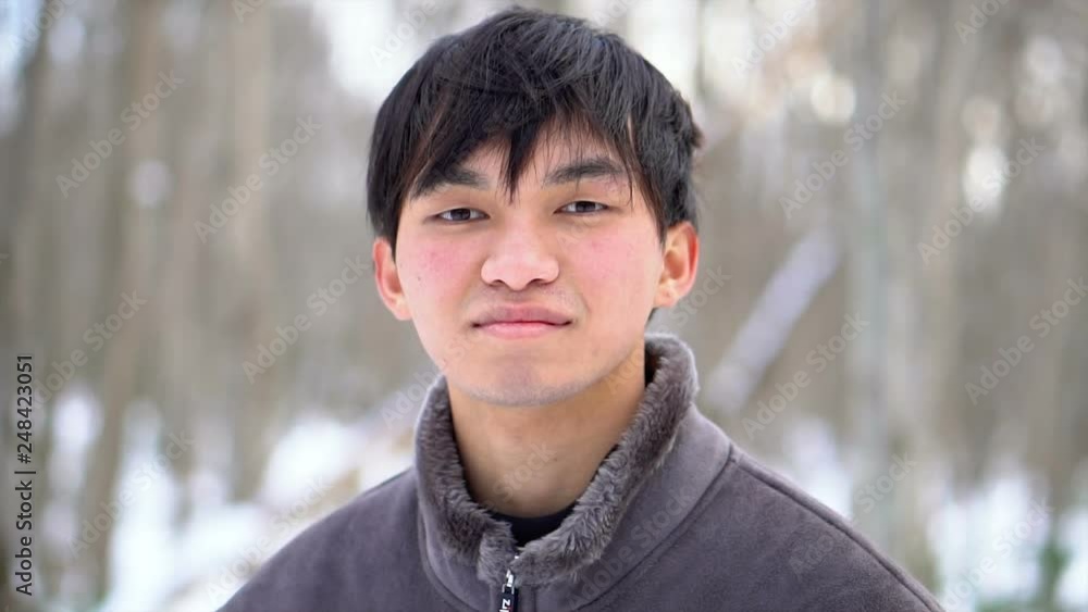 Happy Smiling Young Asian Man In Snowy Winter Scene Happy Smiling Young Asian Man In Snowy Winter Scene
