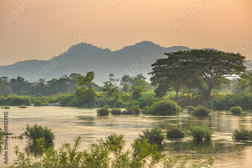 Mekong River 4000 islands Laos, sunrise dramatic sky, mist fog on water, famous travel destination backpacker in South East Asia