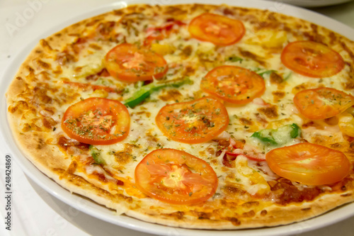  delicious tomato pizza on white plate