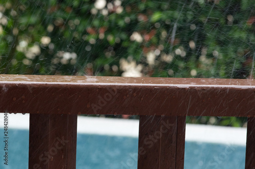 Rain drops on wooden railing