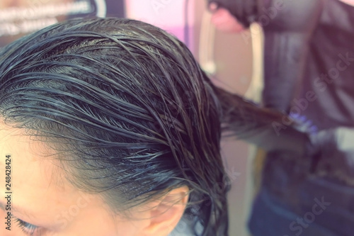 Application of keratin to the hair with a brush. Strengthening the hair with keratin.